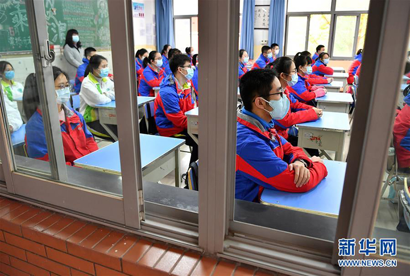 3月30日，陕西省西安中学的高三学生进入校园时测量体温。 当日，陕西省高三年级学生开学复课。